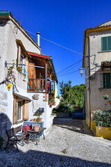 Fototapeta na wymiar A narrow street between the old stone houses of Civitavecchia di Arpino, a medieval village in the Lazio region, Italy.