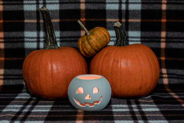 halloween pumpkins and lantern on blanket