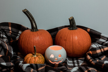 halloween pumpkins and lantern on blanket