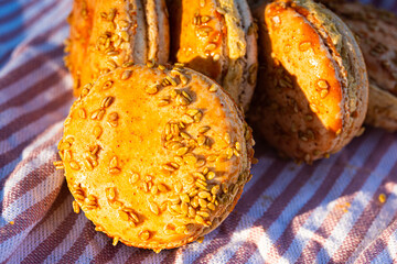 Orange color pumpkin flavor macaron cookies textured with sesame seeds and nuts - 542074479