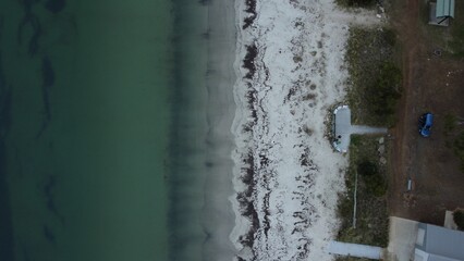 Aerial of a white sand beach and green water