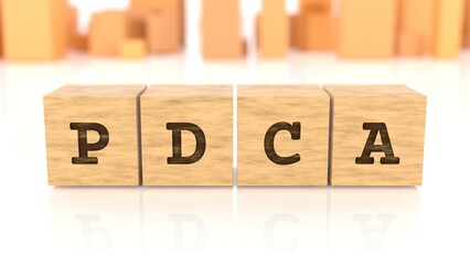 Word with the text PDCA branded on cube wood reflected on the shiny surface. Business concept. In the back are wooden cuboids in different shapes. (3D rendering)