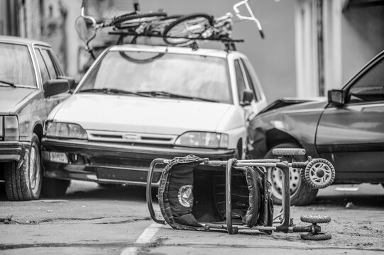 a car accident on the street. an overturned baby stroller against the background of colliding cars