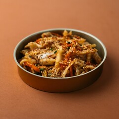 Selective focus shot of a bowl of food on an orange background
