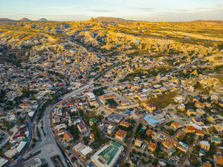 Fototapeta premium Panoramic drone view of Nevsehir town in the Capadoccia valleys, rock formations in the Central Anatolia Region of Turkey. High quality photo