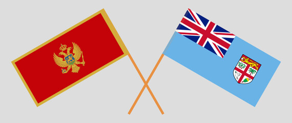 Crossed flags of Montenegro and Fiji. Official colors. Correct proportion