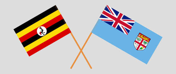 Crossed flags of Uganda and Fiji. Official colors. Correct proportion