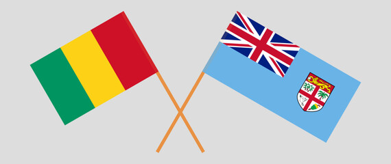 Crossed flags of Guinea and Fiji. Official colors. Correct proportion