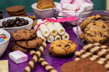 Chocolate and biscuits background. Chocolate and biscuits background. Many pieces of chocolate, candies, cookies, biscuits, cakes, donuts, and other sweets. Milk chocolate and dark chocolate, waffle c