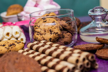 Chocolate and biscuits background. Chocolate and biscuits background. Many pieces of chocolate, candies, cookies, biscuits, cakes, donuts, and other sweets. Milk chocolate and dark chocolate, waffle c