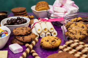 Chocolate and biscuits background. Chocolate and biscuits background. Many pieces of chocolate, candies, cookies, biscuits, cakes, donuts, and other sweets. Milk chocolate and dark chocolate, waffle c