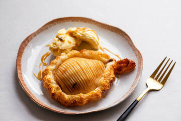 Hasselback pear in puff pastry with vanilla ice cream