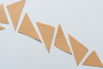 paper triangles with ragged edges on blank paper