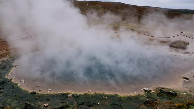 natural geothermal area in Iceland. geothermal iceland geyser. steam from geyser. slow motion.