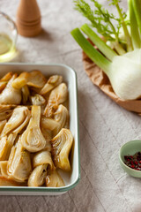 Dish of baked fennel on a kitchen table