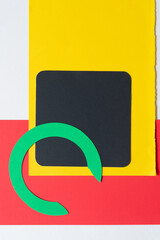 black square, green circle shape, yellow and red paper on blank paper