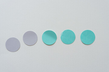 set of paper discs on blank paper