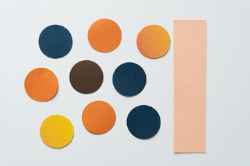 set of paper and cardboard discs and paper bar on blank paper