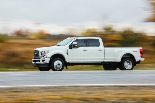 White Ford Truck on a road against blur background