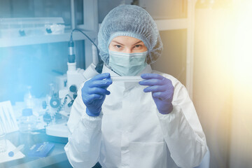 Scientist or nurse in a medical research laboratory is holding a test tube. Biochemical analysis