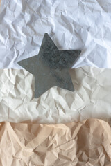 crumpled paper and metal star