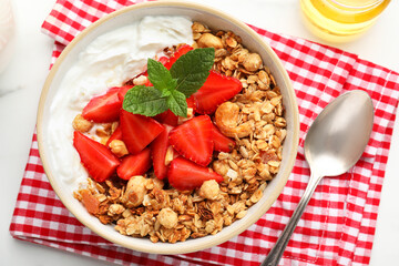 Flat lay composition with tasty granola and ingredients served on white table. Healthy meal