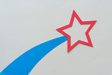 red paper star and blue paper tail