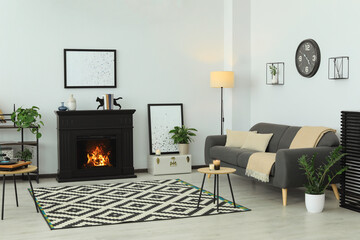 Stylish living room interior with fireplace and comfortable sofa