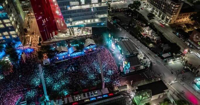Aerial view of a crowd enjoying in a live Music Festival at night, timelapse video 
