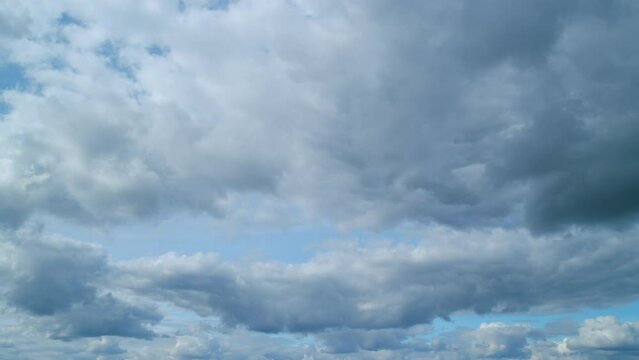 Cirrus and cumulus on different layers clouds blue sky panorama background and copy space. Natural beautiful scene. Cirrus fibratus. Timelapse.
