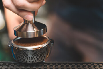 barista making a coffee from coffee powder. closeup of small business of coffee shop.