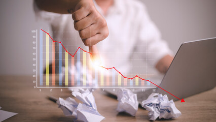 Depressed Businessman Leaning His Head Below a Bad Stock Market Chart