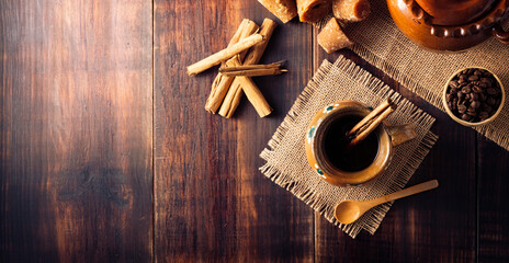 Authentic homemade mexican coffee (cafe de olla) served in traditional handmade clay mug (Jarrito...