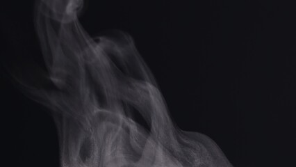 Extreme close up white steam smoke vapor rising up from hot coffee cup, realistic nature steam smoke, mist on black background, 4K. Concept of steam, smoke, vapor, mist, fog