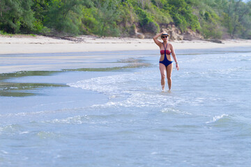 Woman body big with swimsuit walking in morning at beach