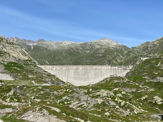 The dam Lucendro or concrete dam on the reservoir lake Lago di Lucendro in the Swiss alpine area of...