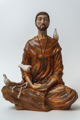Statuette of Saint Francis of Assisi meditating in the position called lotus or Padmasana....