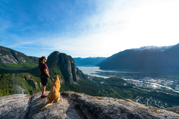 Girl and dog at viewpoint above the ocean - obrazy, fototapety, plakaty