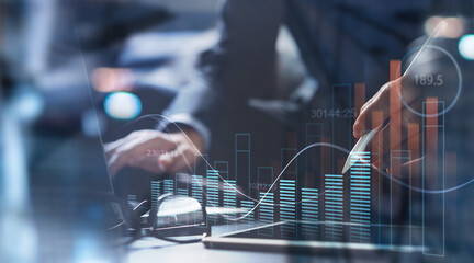 Businessman using digital tablet analyzing sales data and economic growth graph chart. Business...