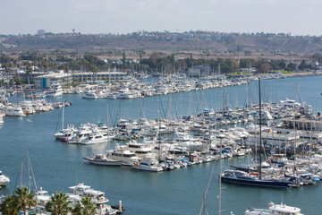 Fototapeta na wymiar Marina Del Rey, California, USA – October 12, 2022: High Close-up View of Yacht Clubs at Marina Del Rey with Beach, Boat Pier Docks, Boats, and Houses