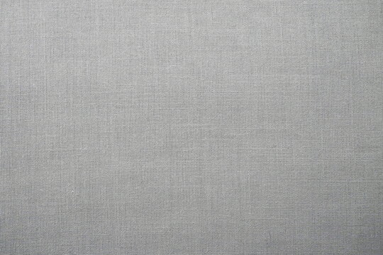 gray background fabric texture. A piece of woolen cloth is neatly laid out on the surface. Weave and textile texture. Dress fabric or for kitchen needs, tablecloth or curtains, close-up. Dash