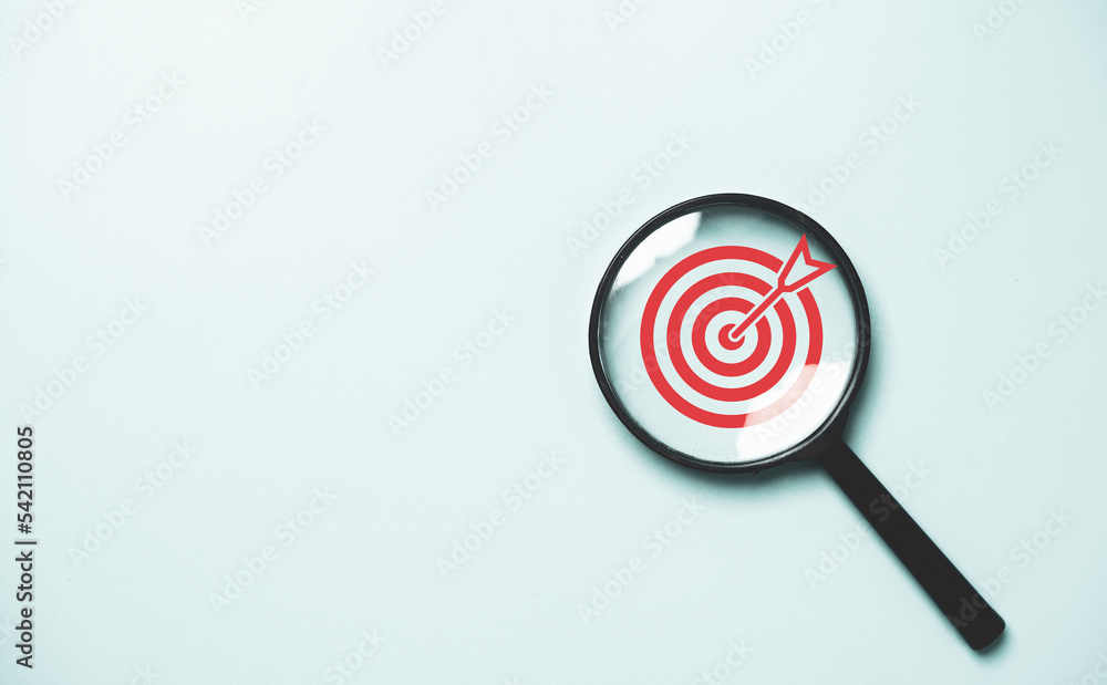 Poster red dartboard inside of black magnifier glass on blue background for setup objective target and busi