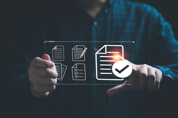 Businessman holding virtual tablet with virtual document and correct mark sign for online paperless...