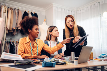 Fashion design concept, young stylish woman fashion designer working in studio office, small business owner creating new fashion design cloth in atelier.
