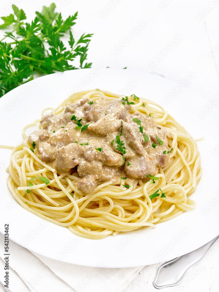 Wall mural meat in creamy sauce with spaghetti on white board