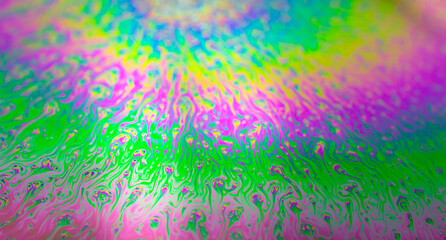 Photo of iridescent surface of soapy water. Space, halographic, psychedelic background for...