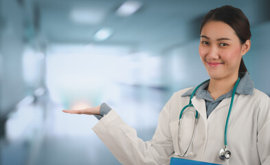 Confident professional female doctor standing with her stethoscope in hospital ward background, Medical specialists showing copy space for your text message or content, Medical and healthcare concept