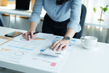 financial, Planning, Marketing and Accounting, portrait of Asian employee checking financial statements using documents and calculators at work