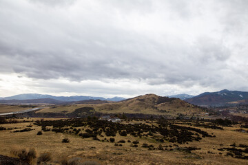 Fototapeta na wymiar Rural hillsides with homes on cloudy day