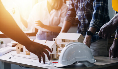 Construction engineer working at blueprint to build large commercial buildings in office. Engineering tools and construction concept.